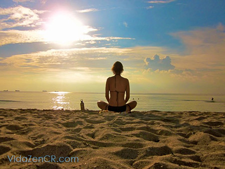 Person meditating during beautiful sunset in Costa Rica