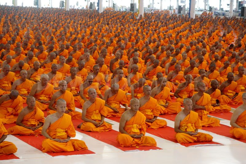 picture of a very large grou of monks meditating